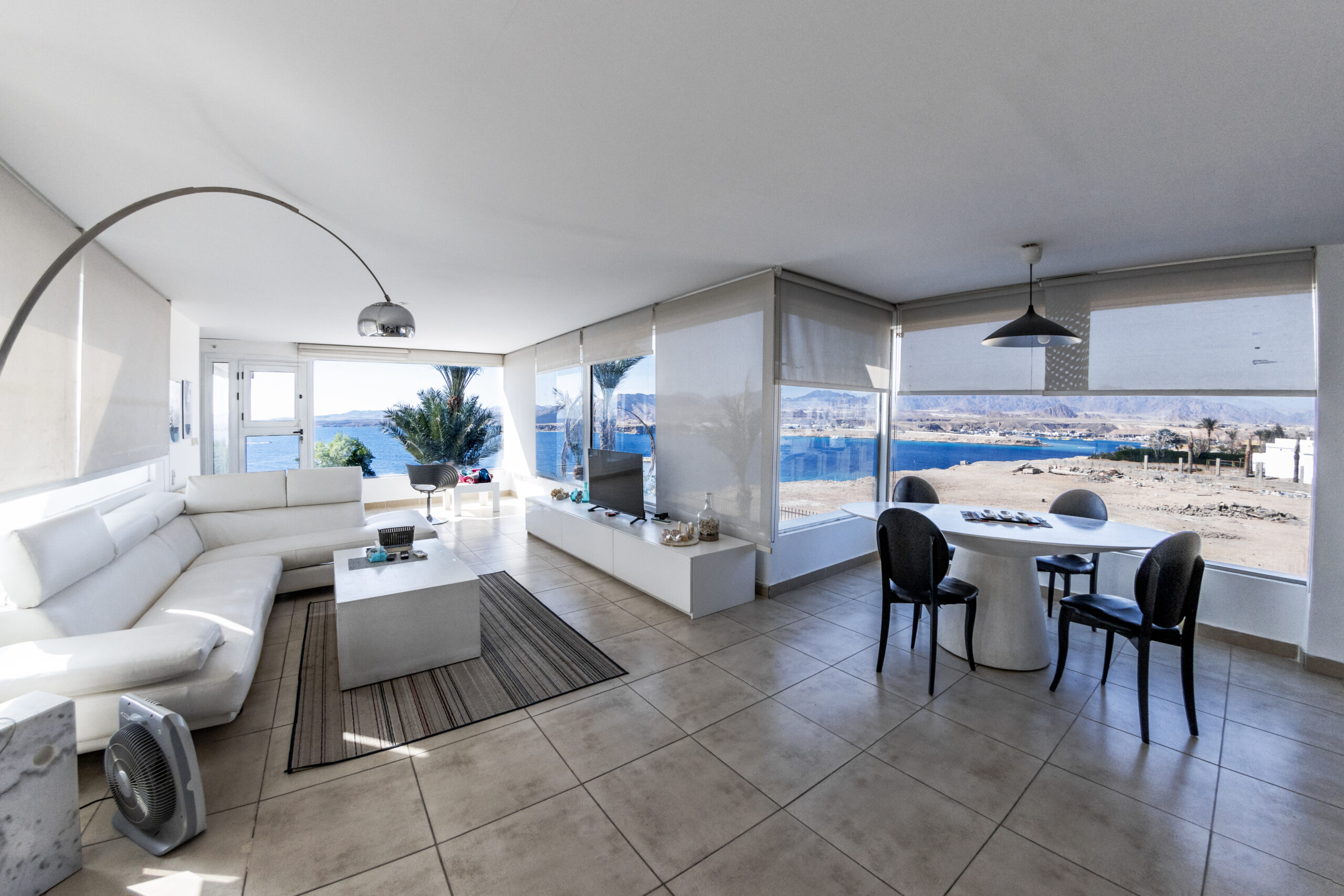 Seafront living room with floor-to-ceiling glass windows – rental property by Dream Home by Carla Fuochi